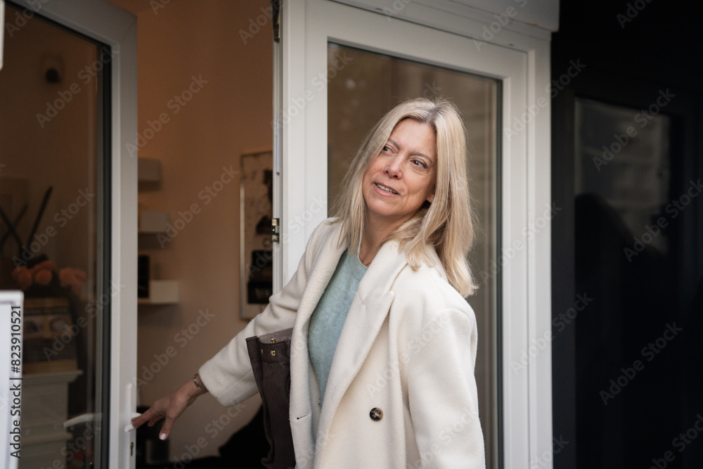 Mature Woman Walking On The Street Entering A Beauty Clinic Center. Mature Woman Walking On The Street Entering A Beauty Clinic Center.