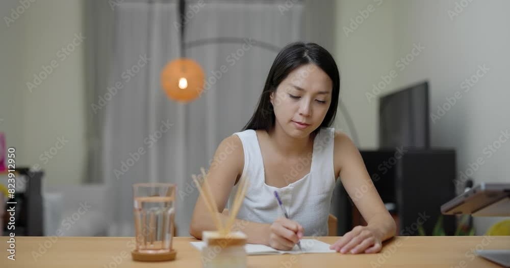Woman write on the notebook at home Woman write on the notebook at home