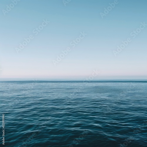 The ocean is calm and peaceful  with a clear blue sky above