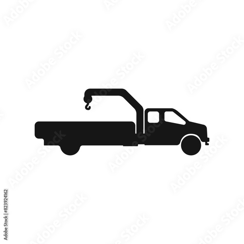 Truck manipulator vector icon. Black car with crane vector. Tow truck icon. Wheel loader logo. Truck silhouette vector. Vector illustration.