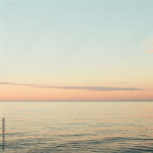 A beautiful ocean view with a pink and orange sky