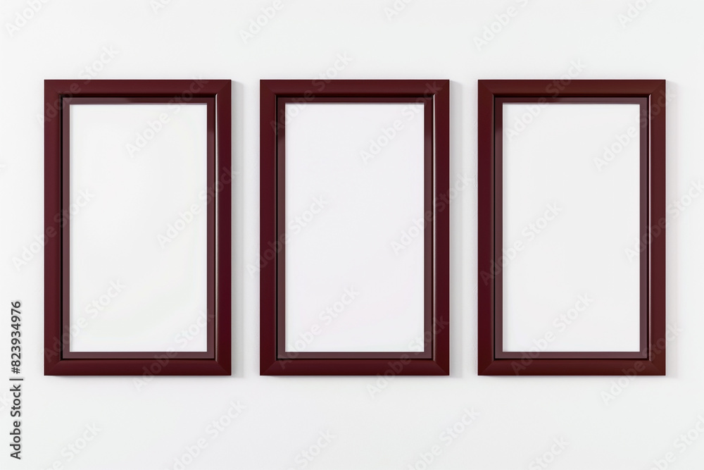 three empty posters in maroon frames against a white background.