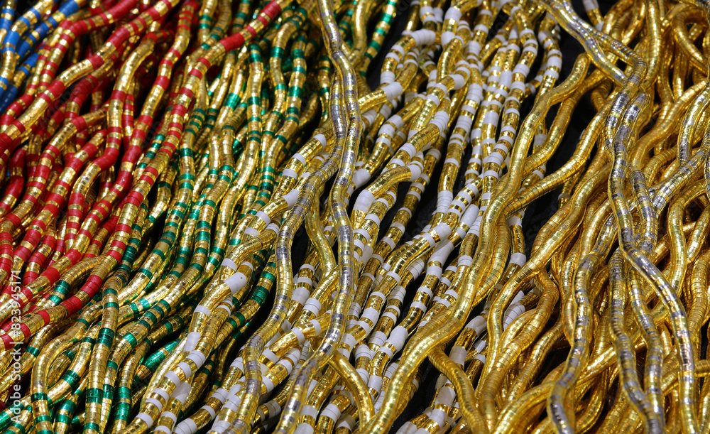 background of necklaces made with gold inserts and vibrant hues offering endless customization options in a jewelry store background of necklaces made with gold inserts and vibrant hues offering endless customization options in a jewelry store