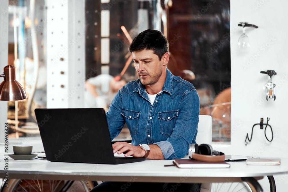 Laptop, engineer and man metal worker in workshop typing email for industrial project order. Technology, professional and male blacksmith working on computer for industrial trade career in garage.