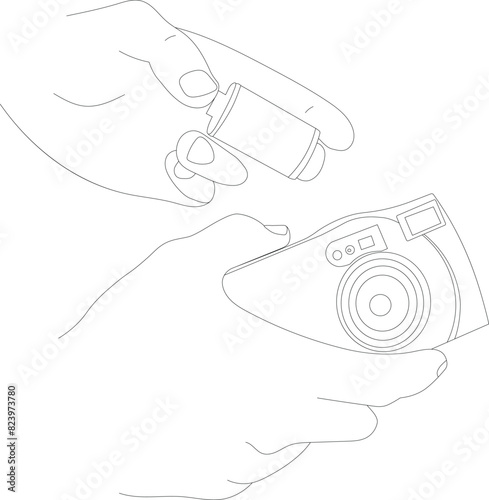Hand holds a film camera in one hand and film roll in another line drawing art