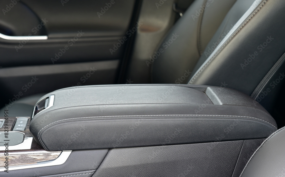 Obraz premium Armrest in the luxury passenger car, front seats