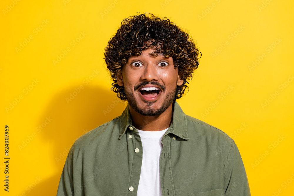 Fototapeta premium Portrait photo of young funny hispanic guy in khaki shirt speechless looking at you unexpected isolated on yellow color background