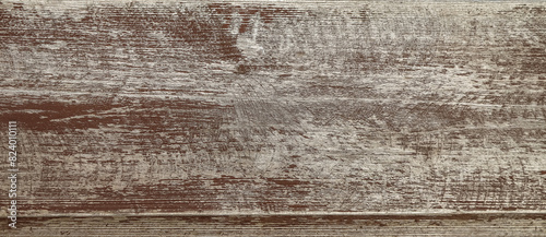 Texture of the old wooden broad panel covered with peeled off brown paint as a background
