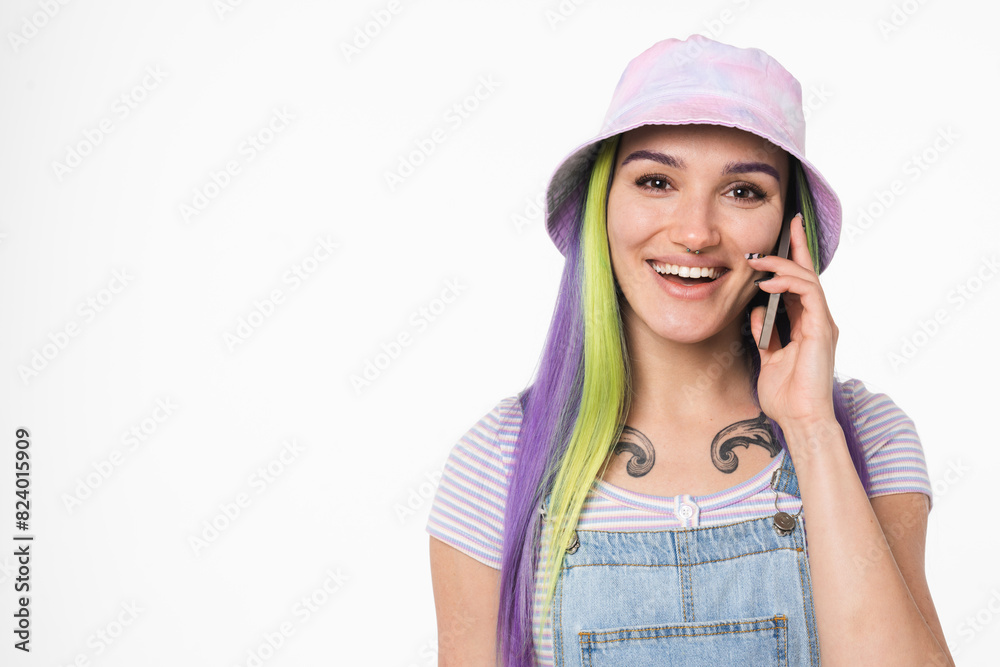 Closeup portrait of young teenage woman girl hipster with colorful dyed hair talking on cellphone with friends with good connection, using mobile applications online isolated in white background Closeup portrait of young teenage woman girl hipster with colorful dyed hair talking on cellphone with friends with good connection, using mobile applications online isolated in white background