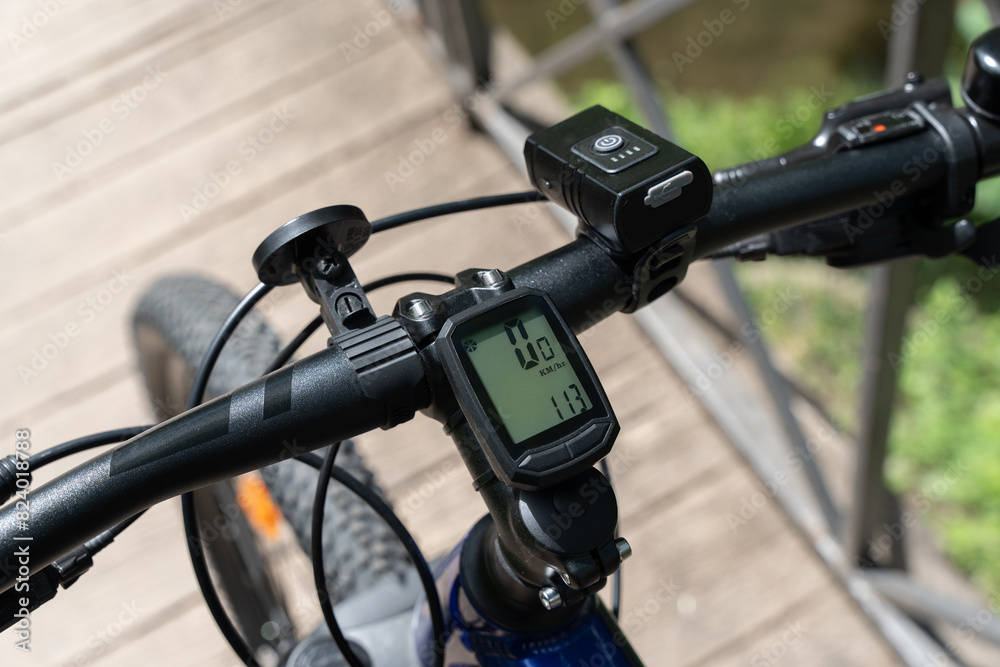 Close-up of mountain bicycle handlebar with bike computer Close-up of mountain bicycle handlebar with bike computer