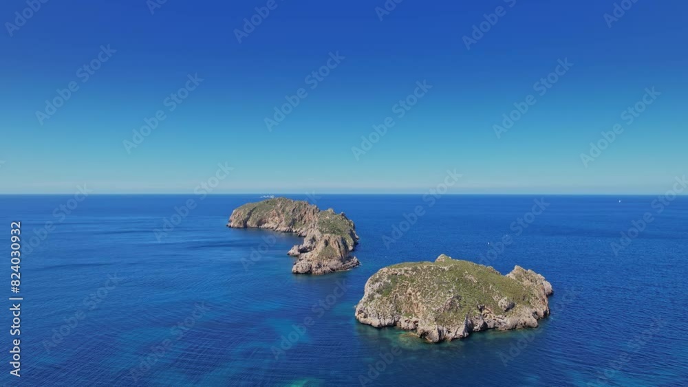 Two Small Islands Rise From the Ocean in Mallorca, Spain Two Small Islands Rise From the Ocean in Mallorca, Spain
