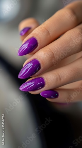 Close-up of hand with purple manicured nails. Macro shot of fingernails with glossy purple nail polish.
