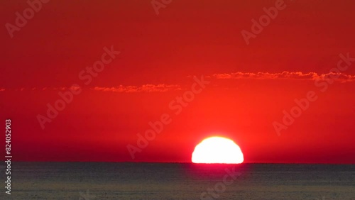 timelapse sunrise sun rising in reddish sea coast valencia spain photo