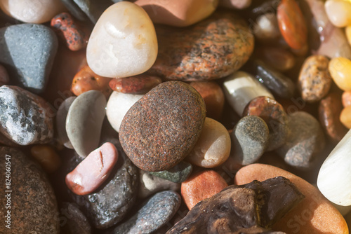 Sea rocks background. Different form colorful smooth stones.