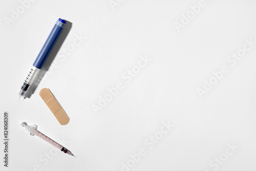 Empty syringes with plaster on white background