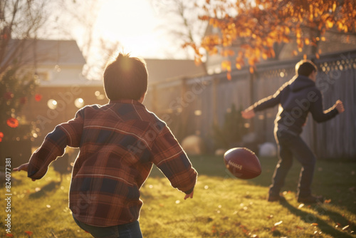 Young boys enjoy an autumn afternoon playing football in a backyard, surrounded by golden leaves.