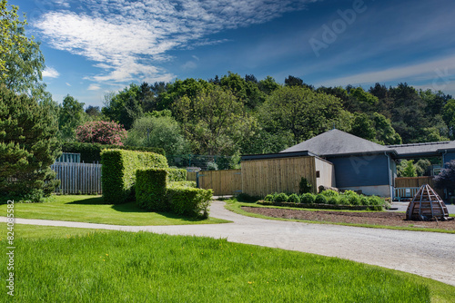 Foto Modern house with garden and gravel path