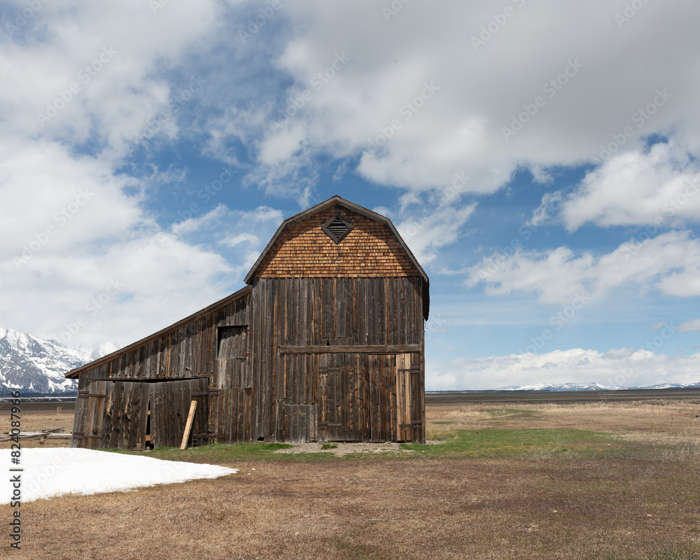 Old barn with early spring landscape and wispy clouds Old barn with early spring landscape and wispy clouds