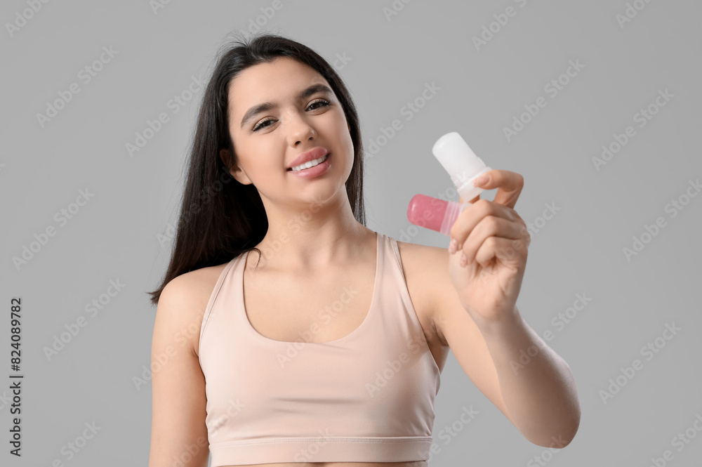 Happy smiling young woman with crystal deodorants on white background Happy smiling young woman with crystal deodorants on white background