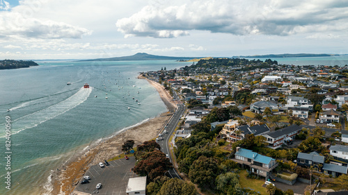 Fototapeta Naklejka Na Ścianę i Meble -  Aerial View from the Beach, Green Trees, City Streets and Waves - Tahuna Torea, Bucklands Beach View in New Zealand - Auckland Area	