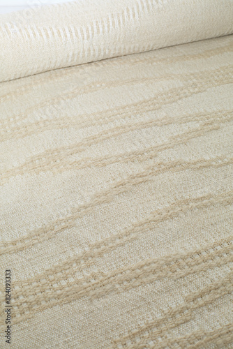 Beige and off-white wave pattern. Vintage woven upholstery fabric texture. Close-up detail photograph.