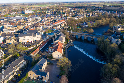 Aerial photo of the town centre of Wetherby in West Yorkshire in the UK, showing the River Wharfe with traffic driving over the small bridge that leads in to the town centre, taken in the winter.
