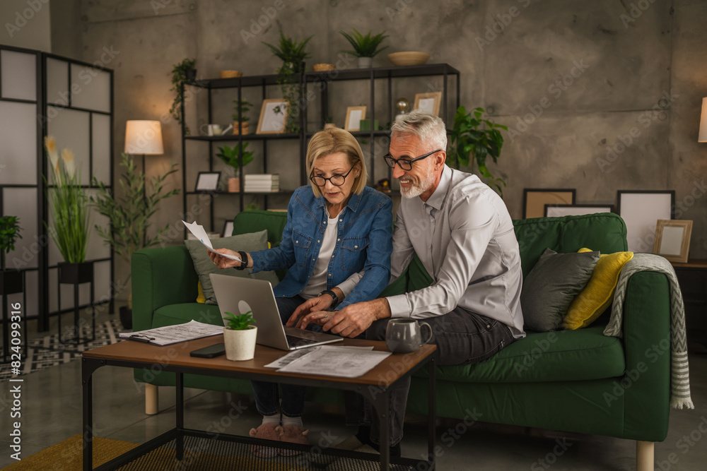 Mature senior couple husband and wife work together form home Mature senior couple husband and wife work together form home