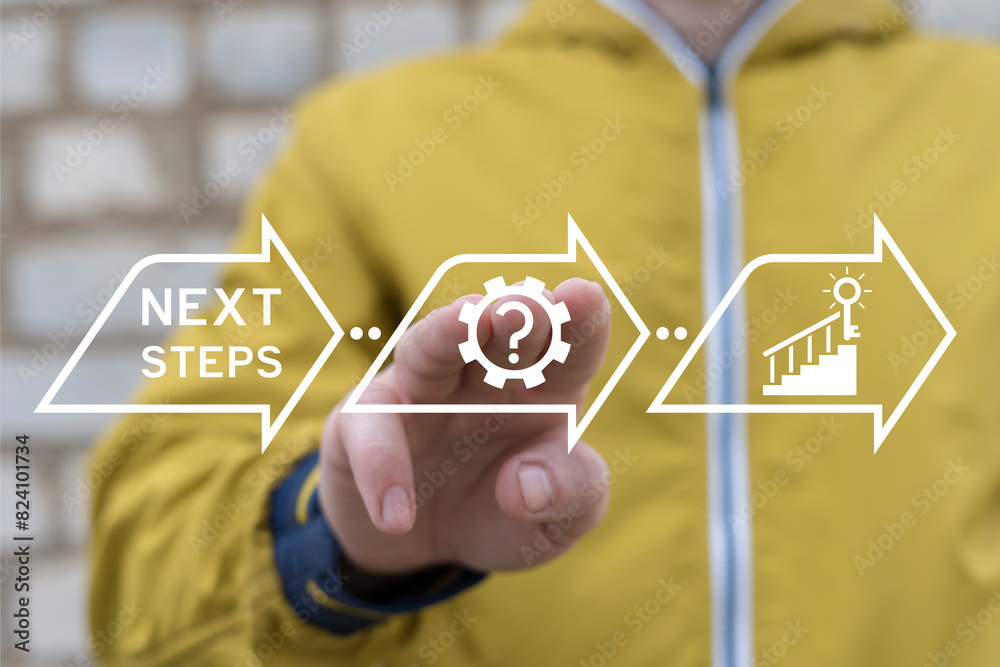 Man working on virtual touch screen sees inscription: NEXT STEPS. Next steps business concept. Next step of work, plan, strategies, vision, project implementation, new opportunities and execution.