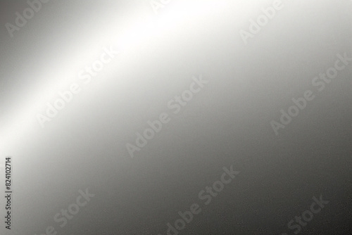 A tight shot of a polished metal surface adorned with a silver pattern, overlain by silver metallic foil
