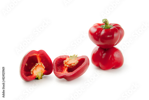 Two whole and halves of red bell pepper isolated on white background with clipping path. .