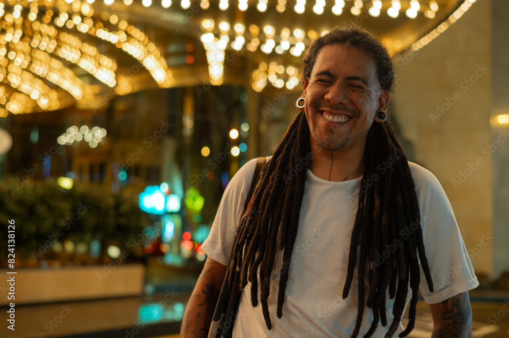 man with dreads smiling in the street with many colors man with dreads smiling in the street with many colors