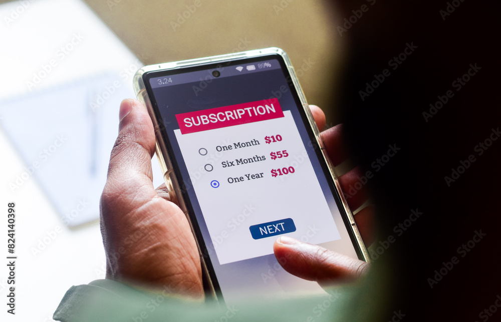 Man choosing a subscription plan for one year using mobile applications for newspaper or delivery or online streaming service. Man choosing a subscription plan for one year using mobile applications for newspaper or delivery or online streaming service.