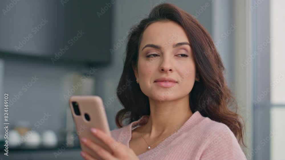 Smiling woman looking smartphone reading message with good news at home closeup Smiling woman looking smartphone reading message with good news at home closeup
