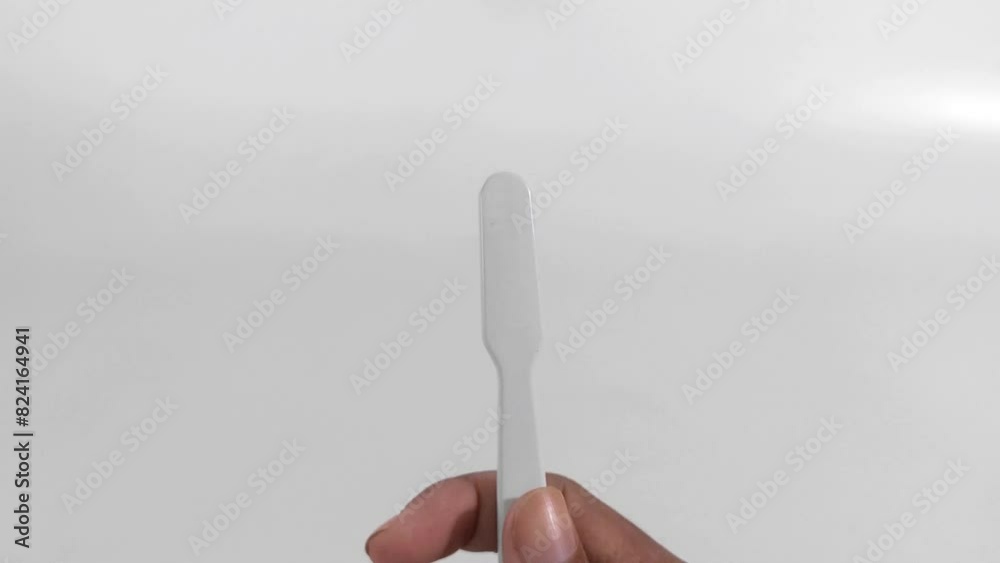 Close-up of a man's hand holding a new toothbrush isolated on a white background. video illustration of rotating a toothbrush Close-up of a man's hand holding a new toothbrush isolated on a white background. video illustration of rotating a toothbrush
