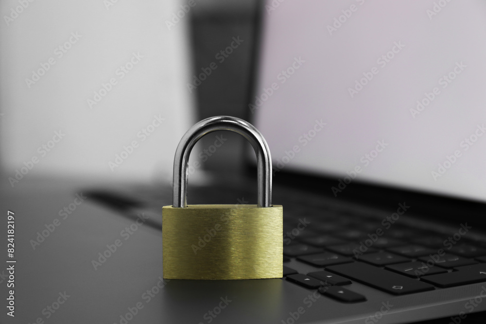 Cyber security. Metal padlock on laptop, closeup Cyber security. Metal padlock on laptop, closeup