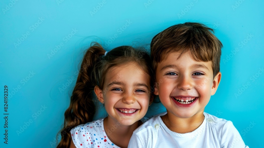 portrait of children in front of clean blue background portrait of children in front of clean blue background