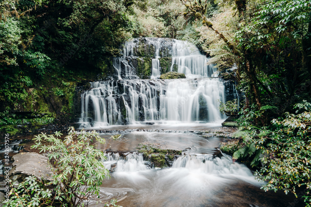 Obraz premium Tiered Waterfall Flowing in Forest Long Exposure Slow Shutter