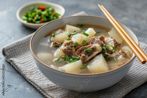 Double-boiled Spare Rib Soup with Chinese Yam and Snow Pear with chopsticks served in a dish isolated on mat side view on grey background - generative ai