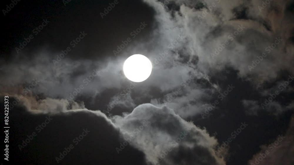 NORMAL SPEED VIDEO OF DRAMATIC NIGHT SKY WITH FULL MOON AMONG THE DARK CLOUDS NORMAL SPEED VIDEO OF DRAMATIC NIGHT SKY WITH FULL MOON AMONG THE DARK CLOUDS