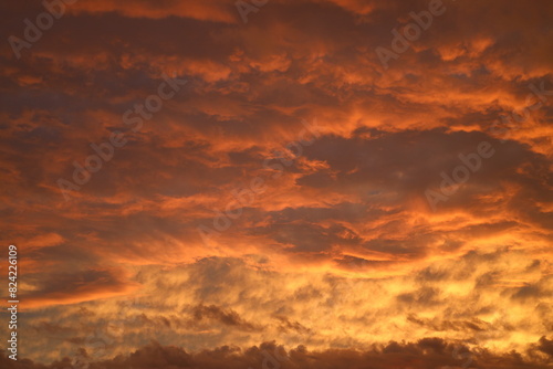 low storm clouds painted in fiery hues at sunset