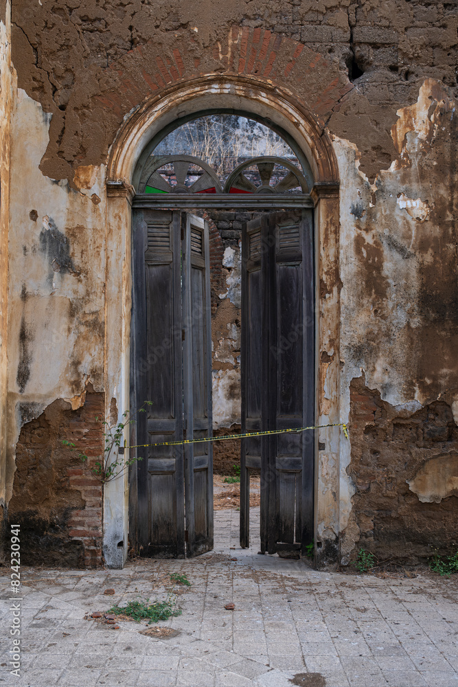 Abandoned old crumbling red brick colonial building. Old school of arts in Santa Ana, El Salvador.