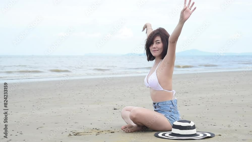 Bikini Women relax on paradise beach. Cheerful woman laydown on beach in bikini swimwear smile happiness face look at camera. Tropical summer beach island white sand blue sea. Beautiful landscape Bikini Women relax on paradise beach. Cheerful woman laydown on beach in bikini swimwear smile happiness face look at camera. Tropical summer beach island white sand blue sea. Beautiful landscape