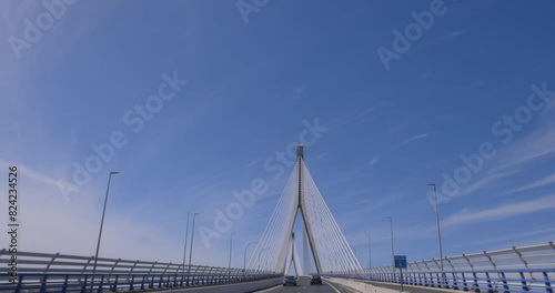 Alamillo bridge in Sevilla with cars on road and blue sky tracking shot photo