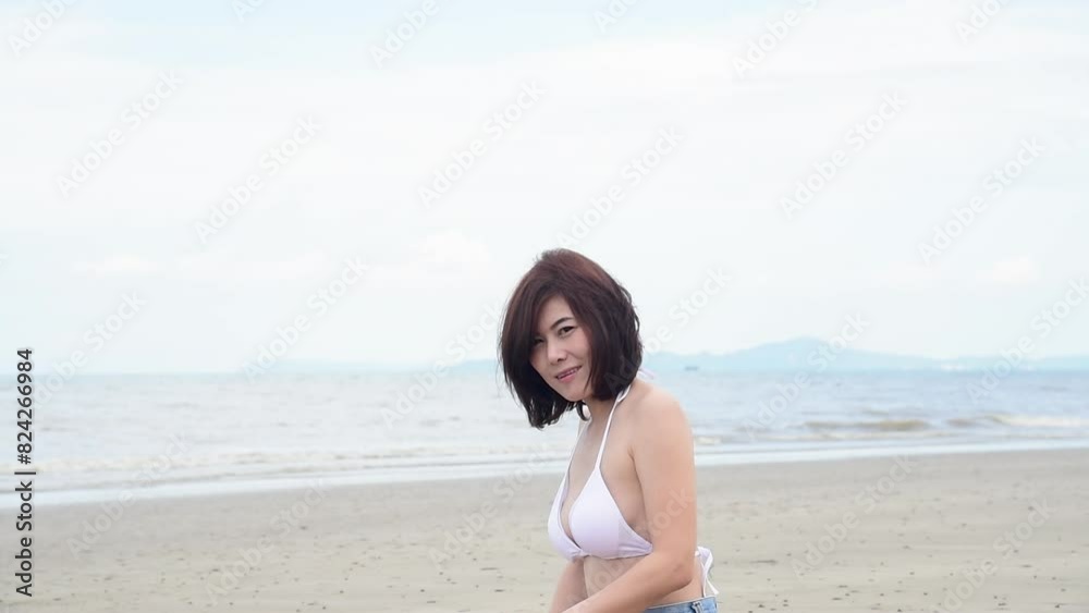 Bikini Women relax on paradise beach. Cheerful woman laydown on beach in bikini swimwear smile happiness face look at camera. Tropical summer beach island white sand blue sea. Beautiful landscape Bikini Women relax on paradise beach. Cheerful woman laydown on beach in bikini swimwear smile happiness face look at camera. Tropical summer beach island white sand blue sea. Beautiful landscape
