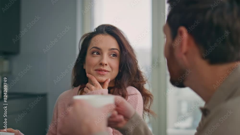 Loving spouses talking kitchen closeup. Happy laughing pair drinking coffee