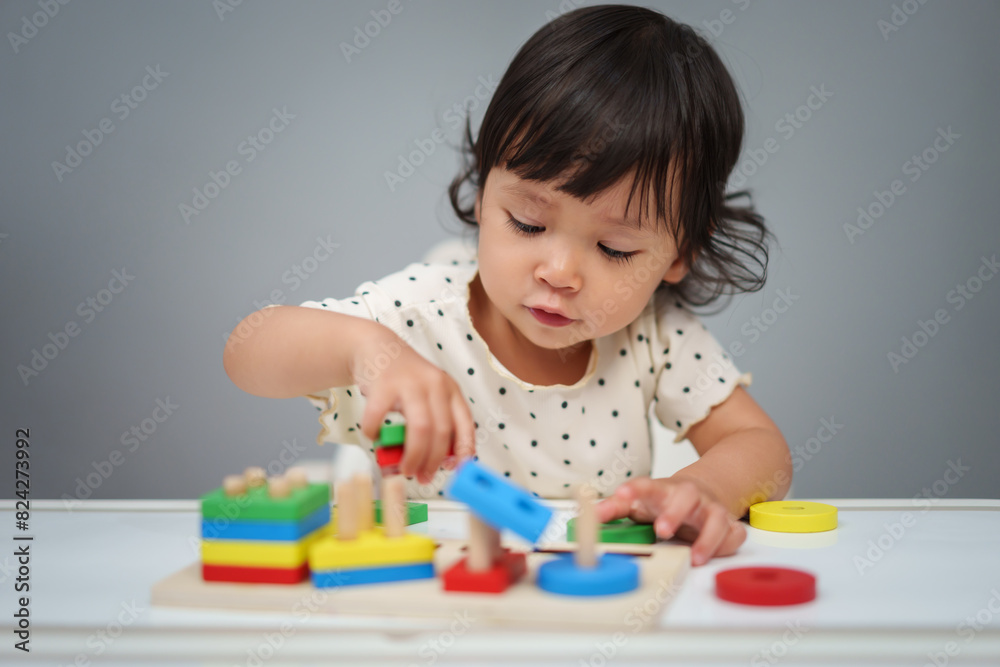 toddler baby girl playing with wooden educational geometric on table toddler baby girl playing with wooden educational geometric on table