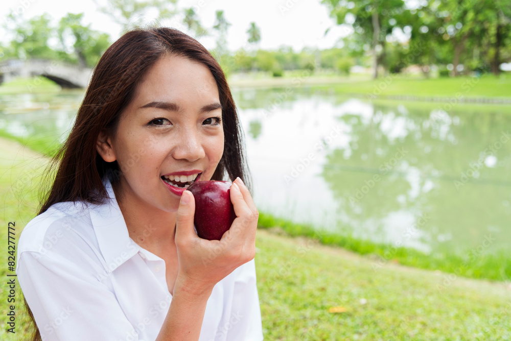 Young asian woman eating red Apple Healthy. Girl workout holding organic apple fruit healthy lifestyle. Wellness Asian women eat red apple smile face look at camera. Beauty health care lifestyle Young asian woman eating red Apple Healthy. Girl workout holding organic apple fruit healthy lifestyle. Wellness Asian women eat red apple smile face look at camera. Beauty health care lifestyle