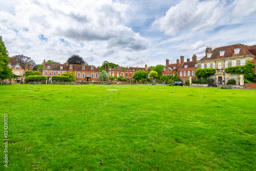 Historic brick townhomes line the Choristers Square Park, in the Cathedral Close district alongside the medieval cathedral, in Salisbury, England, UK.