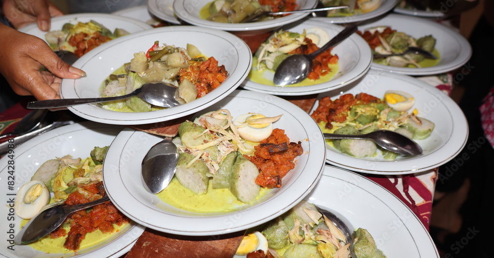 Lontong Sayur, served with chicken, balado potatoes, vegetables lodeh eggplant coconut milk and crackers