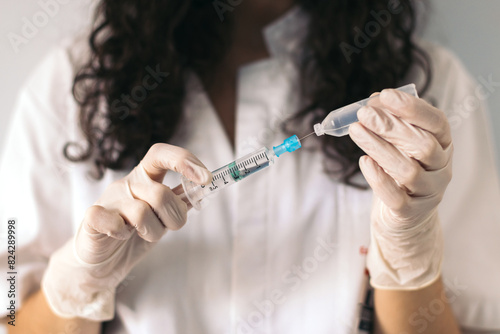 Nurse with syringe and serum.